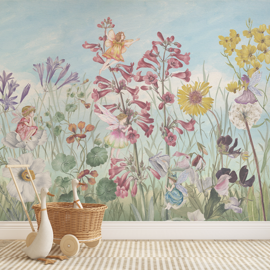 Wallpaper with fairies and flowers in a child's room with toys.