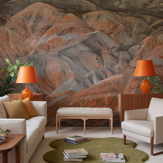 Living room with a mountain mural wall, orange lamps, and a green rug.