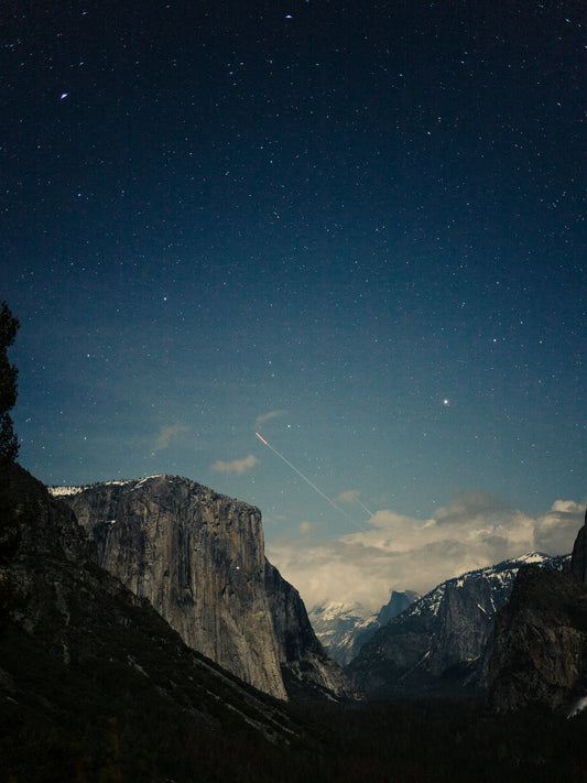 Day into night sky above mountains