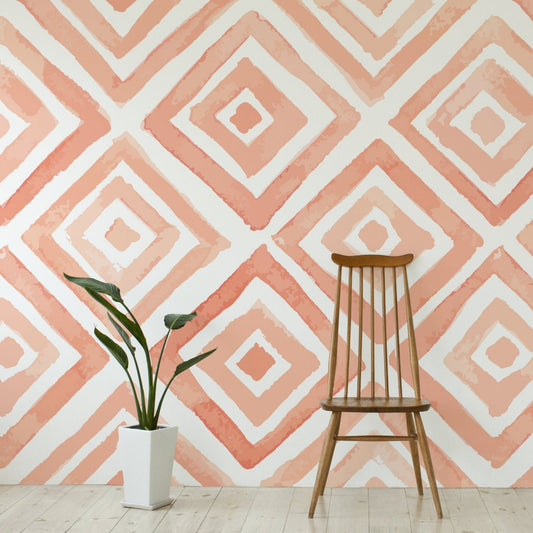 Peach wallpaper mural with a wooden chair and a plant | WallpaperMural.com