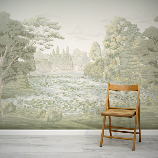 Wooden chair in front of a scenic wall mural with trees and a river.