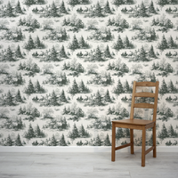 Wooden chair in front of a wall with winter landscape wallpaper featuring trees and deer.