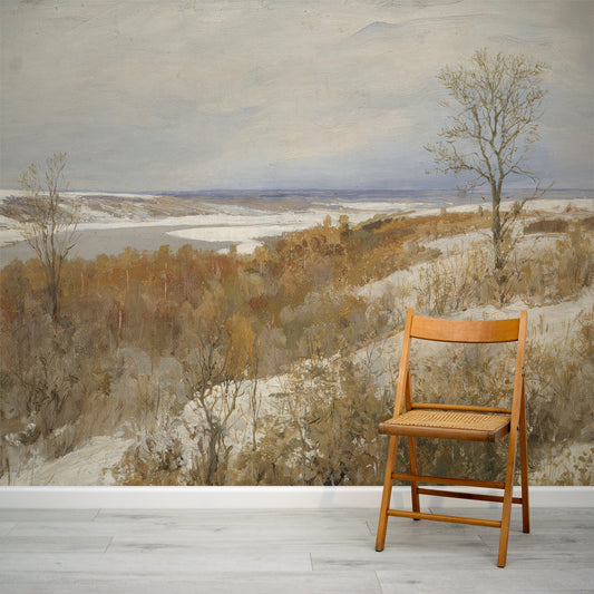 Wooden chair in front of a large landscape painting with trees and a body of water.