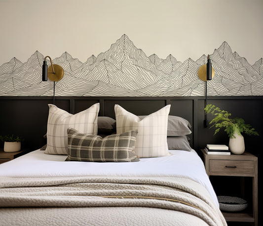 Bedroom with mountain-themed wallpaper, pillows, and nightstands.