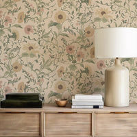 Decorative wall with the Clytie floral pattern, wooden sideboard with lamp and books, and decorative bowl.