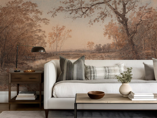 Living room with a white sofa, decorative pillows, and a wall mural of a landscape.