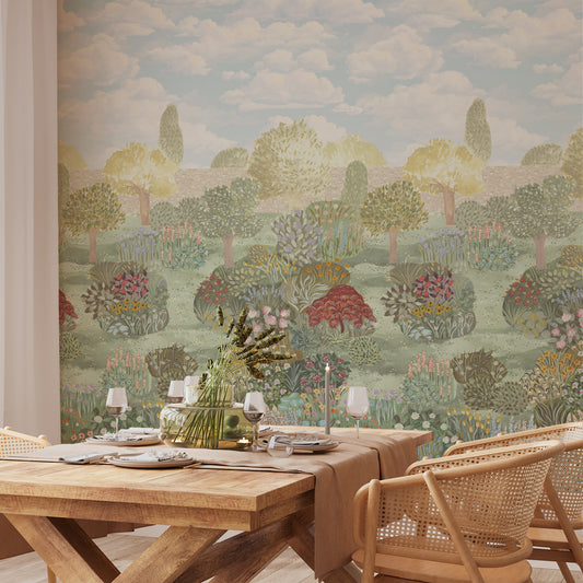 Dining room with wooden table and chairs against a scenic wall mural.