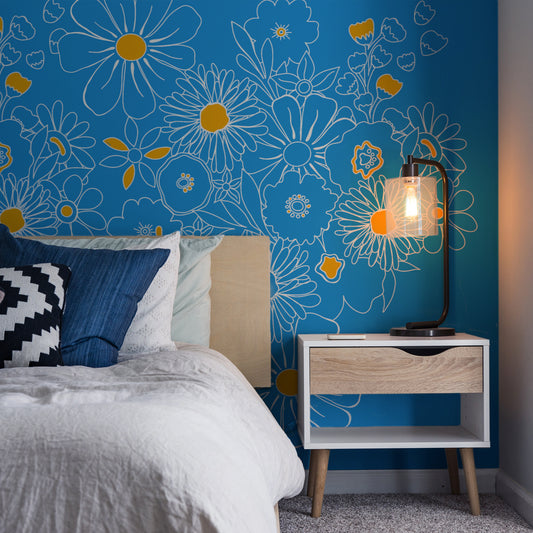 Electric Blooms Wallpaper In Bedroom With Bed and Blue Cushios And Side Light
