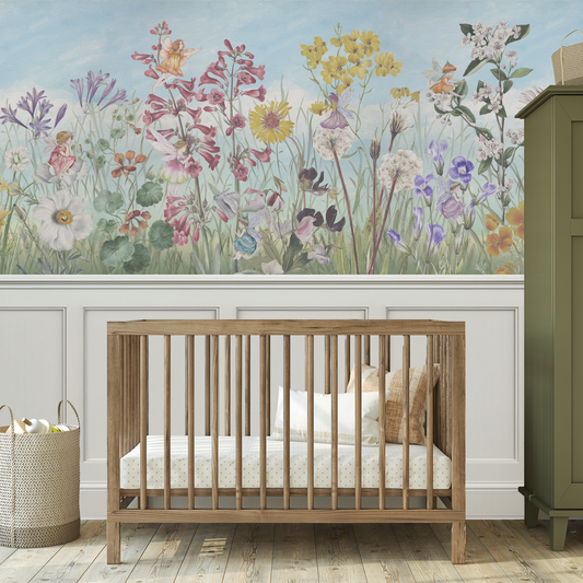 Wooden crib in a room with floral wallpaper and a green cabinet.
