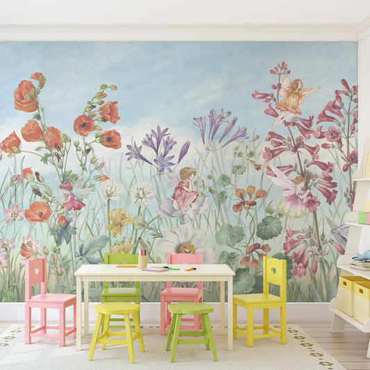 Children's room with colorful chairs and table against a floral wall mural.