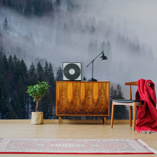 Enchanted Alpine Forest wallpaper in lounge with wooden tabel with black record disc on top as well as wooden chair with red blanket on it
