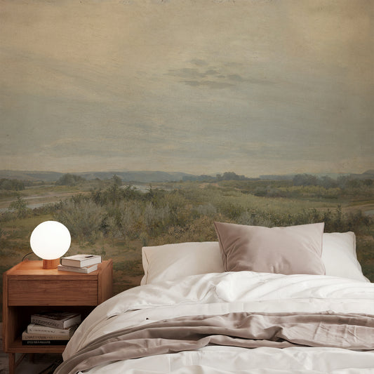 Eowyn Wallpaper in a bedroom with landscape wall mural, wooden nightstand, and books.