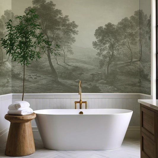 Modern bathroom with freestanding bathtub, wooden stool, and wall mural of a landscape.