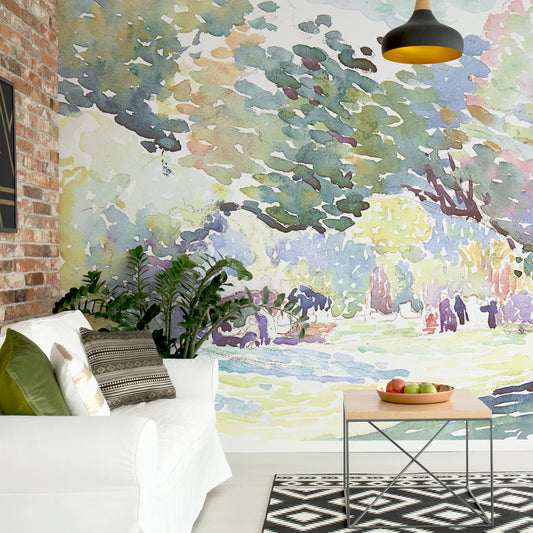 Henri Edmond Cross landscape wallpaper in living room with white sofa and large green plant and small coffee table with green and red apples as well as brick wall