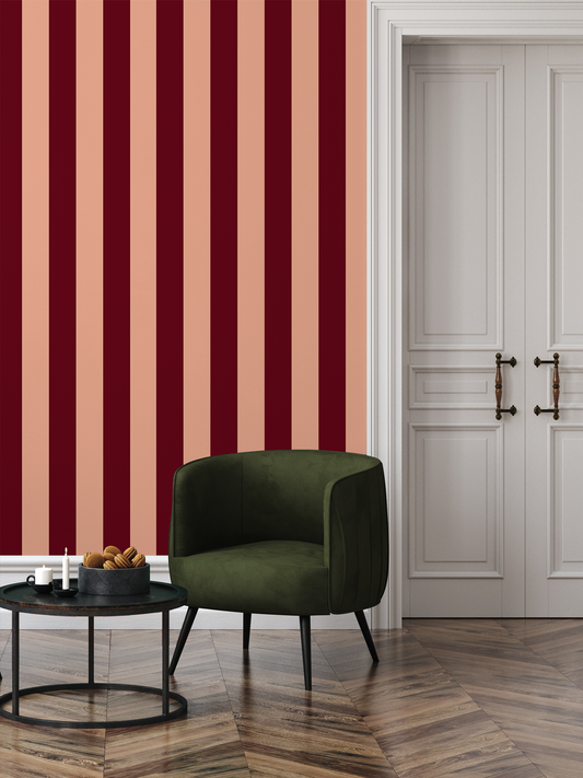 Green armchair in a room with red and beige striped wallpaper