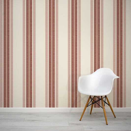 White chair with wooden legs against a striped wallpaper wall.