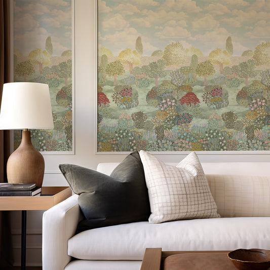Living room with a white sofa, decorative pillows, a lamp, and wall art depicting a landscape.