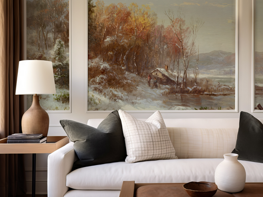Living room with a white sofa, decorative pillows, a lamp, and wall art.