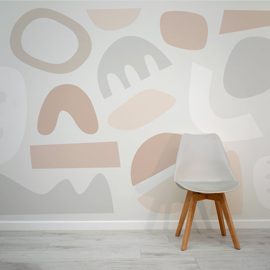 Pastel Puzzles Neutral Calming Abstract Cut-Out Shapes Wallpaper Mural with Grey Chair