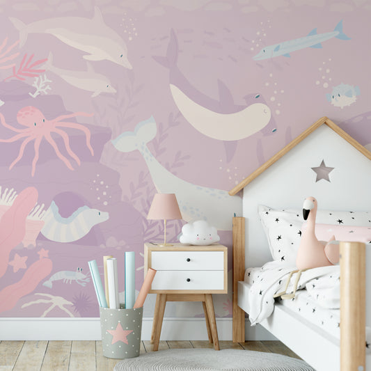 Pink Submerged Fantasia Wallpaper in girl's bedroom with bed in the shape of a house with star bedding sheets and toy flamingo on top of bed