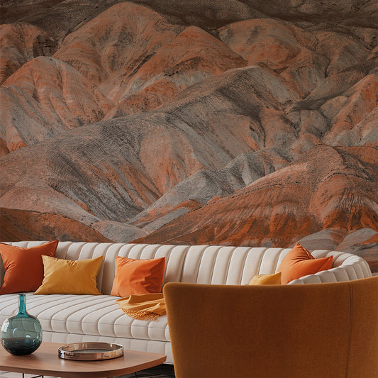 Living room with a mountain mural wall, white sofa, and colorful pillows.