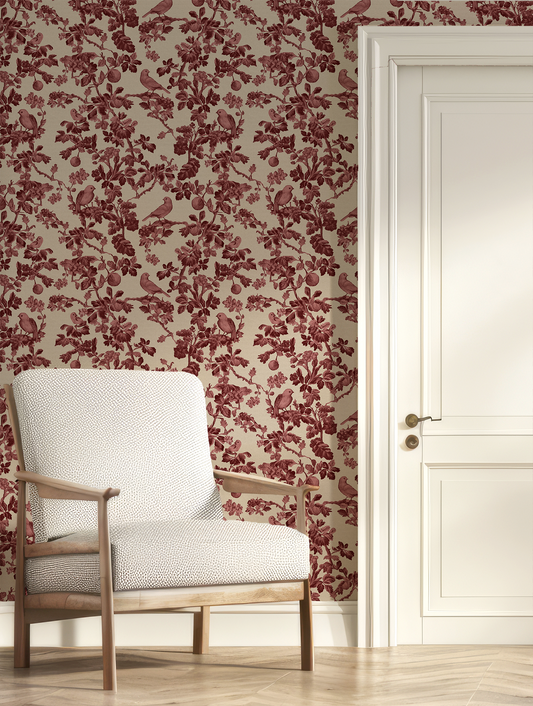 White armchair against a wall with red floral wallpaper and a white door.