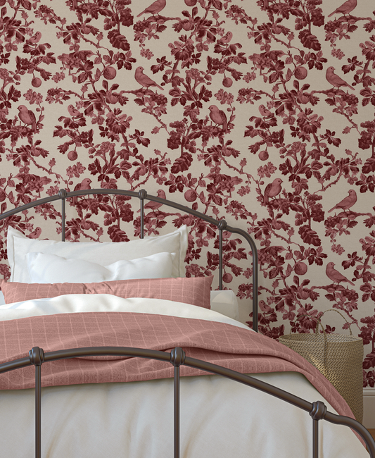 Bedroom with floral wallpaper and a bed with pink bedding.