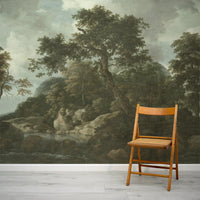 Sylvia Wallpaper with a Wooden chair in front of a large landscape mural with trees and rocks.