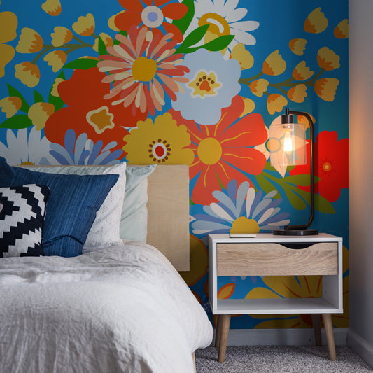 Vibrant Blooms Wallpaper In Bedroom With Dark Blue Bed and Side Lamp On