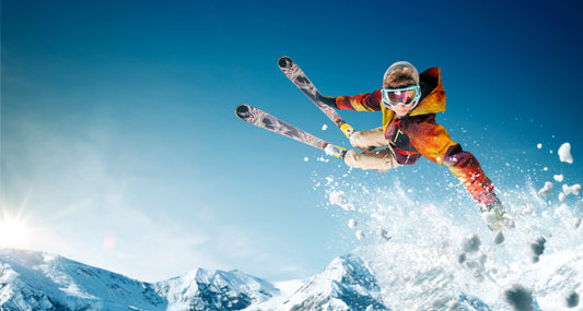 Colourful skier on a Blue background wallpaper mural  | WallpaperMural.com