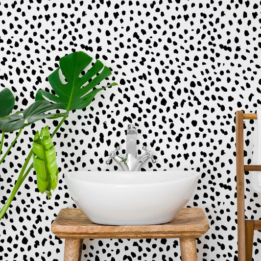 Mini Dalmatian wallpaper mural with a plant and bathroom sink on a wooden stool | WallpaperMural.com